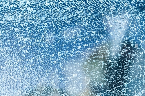 Cracks in glass of shattered car window - Australian Stock Image