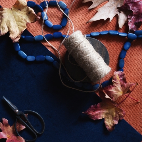 Crafty background of autumn objects on navy and orange - Australian Stock Image