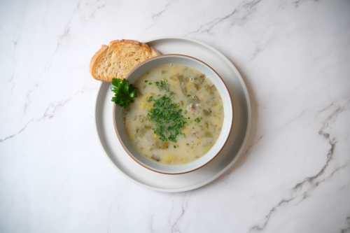 Cream of mushroom soup with a slice of toasted bread. - Australian Stock Image
