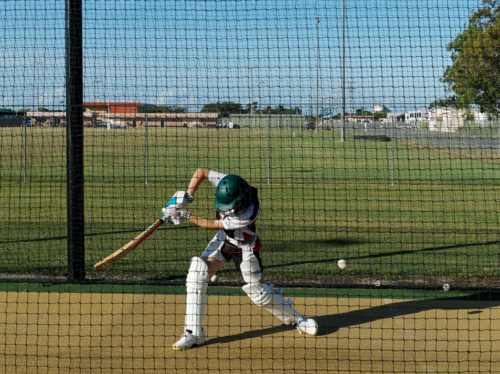 Cricket training and practice in the nets for left handed female cricket player - Australian Stock Image