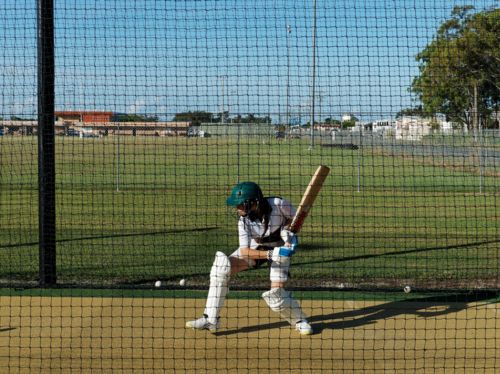 Cricket training and practice in the nets for left handed female cricket player - Australian Stock Image