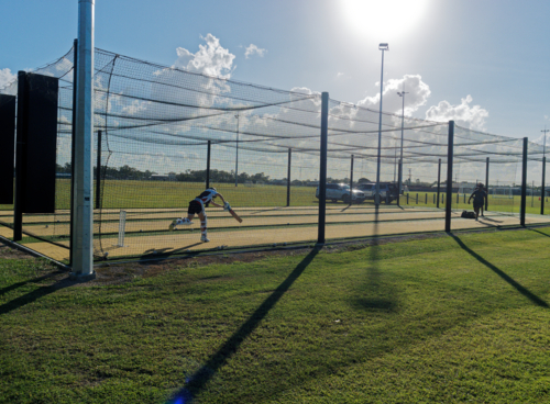 Cricket training and practice in the nets for left handed female cricket player - Australian Stock Image