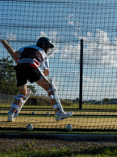 Cricket training and practice in the nets for left handed female cricket player - Australian Stock Image