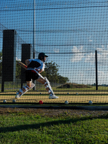 Cricket training and practice in the nets for teen left handed female cricket player - Australian Stock Image