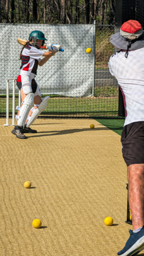 Cricket training in the nets for female left hand batter - Australian Stock Image