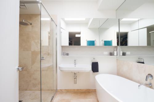 Crisp clean white and marble bathroom in luxury home - Australian Stock Image