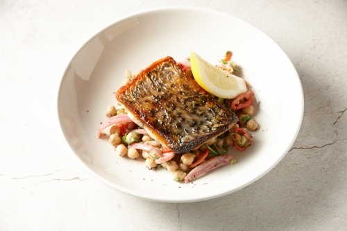 Crispy skin Barramundi with chick pea salad - Australian Stock Image