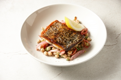 Crispy skin Barramundi with chick pea salad - Australian Stock Image