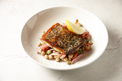 Crispy skin Barramundi with chick pea salad - Australian Stock Image