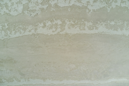 Crusty textures on the surface on a dry salt lake in Western Australia. - Australian Stock Image