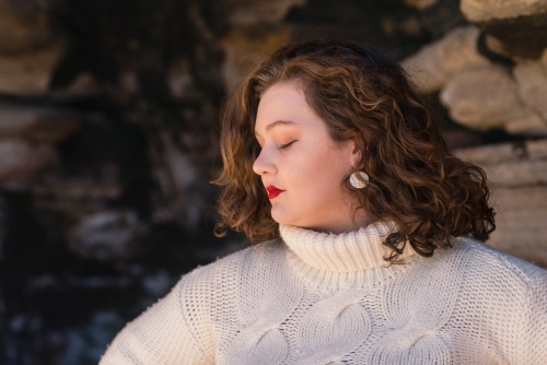 curvy woman wearing white sweater - Australian Stock Image