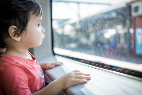 Cute 2 year old boy travels on a Sydney train - Australian Stock Image