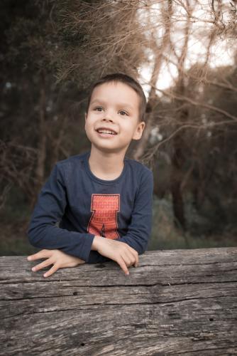 Cute mixed race boy day dreams outside - Australian Stock Image