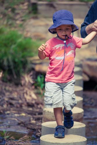 Cute mixed race little boy bushwalking on the Warrumbungles National Park Nature Trail