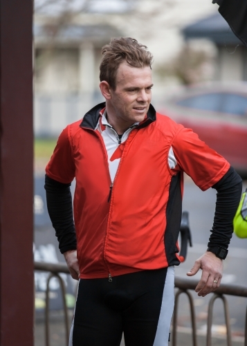Cyclist talking to friends after a morning bike ride - Australian Stock Image