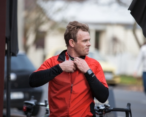 Cyclist unzipping his jacket after a ride
