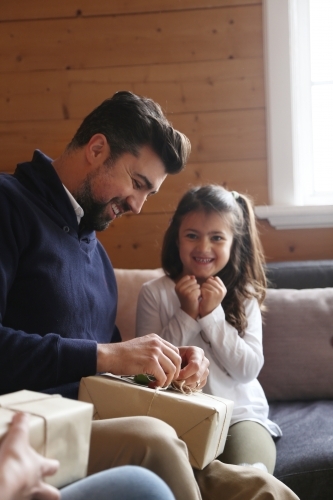 Dad and daughter opening present - Australian Stock Image