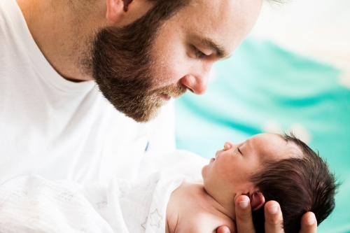 Dad looking at baby - Australian Stock Image