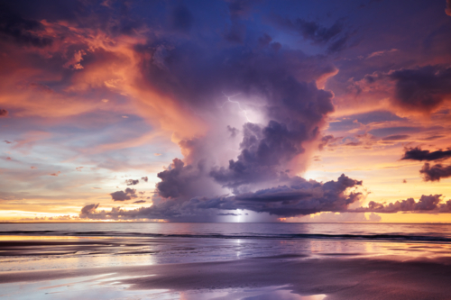 Darwin Sunset Lightning with dramatic anvil cloud over the beach - Australian Stock Image