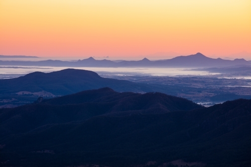 Dawn across the Scenic Rim looking towards a distant Brisbane. - Australian Stock Image