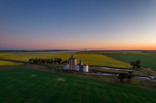 Dawn colours of the sky looking down on the silo storage. - Australian Stock Image