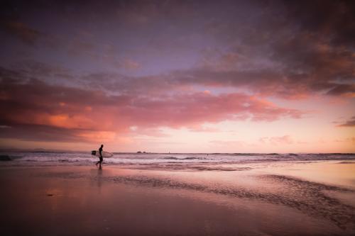Dawn surfer at the beach Byron Bay (high iso)