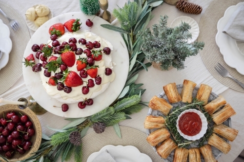 Decorated Christmas table with pavlova and pastries - Australian Stock Image