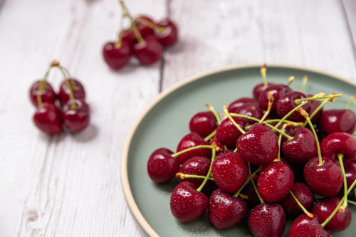 ripe cherries on a plate - Australian Stock Image