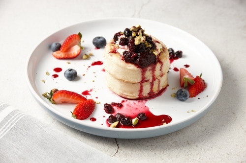 Delicious crumpets with berries and ice cream - Australian Stock Image