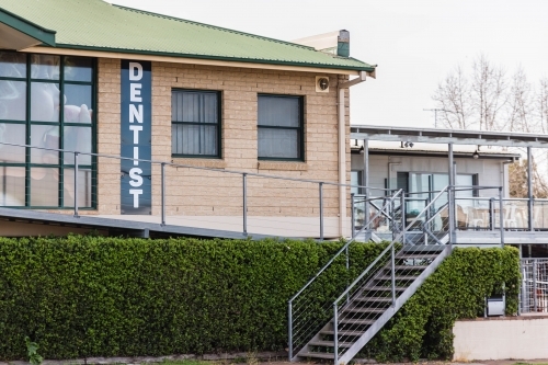 Dentist brick building with bushes and stairs - Australian Stock Image
