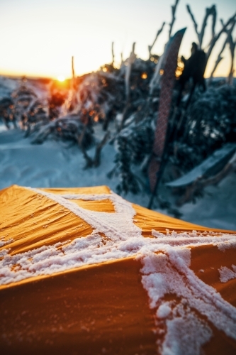 Depth of field view over tent looking at sunrise - Australian Stock Image