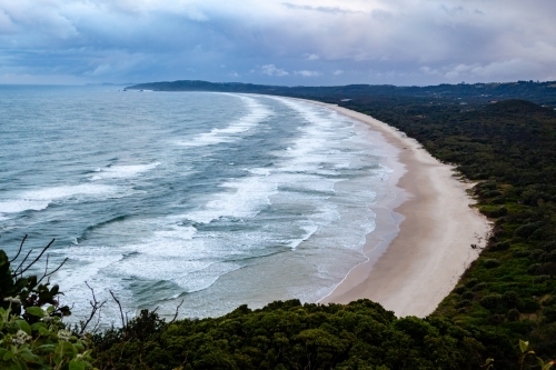 Deserted beach as waves and clouds roll in - Australian Stock Image
