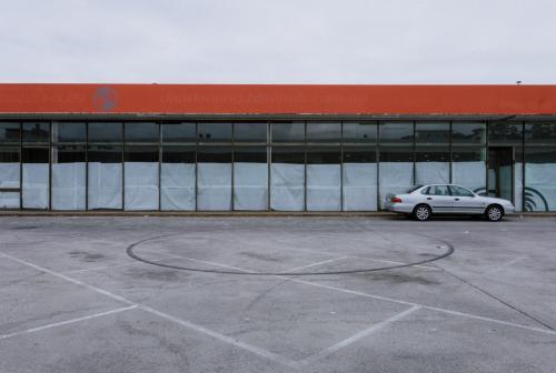 Deserted Car Park with Closed Down Shop