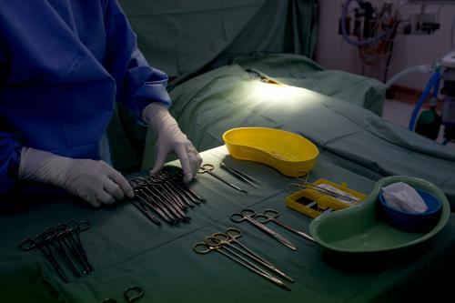 Detail of a nurse preparing equipment for surgery in a hospital operating theatre - Australian Stock Image