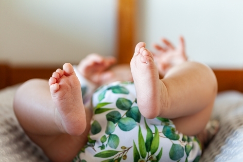 Detail of baby toes and modern cloth nappy - eco friendly lifestyle - Australian Stock Image