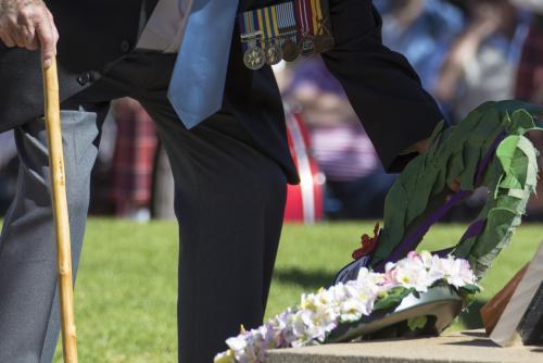 Detail of elderly male digger laying a wreath on ANZAC Day - Australian Stock Image