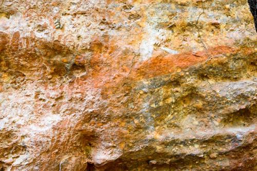Detail shot of bright orange and yellow rock with texture - Australian Stock Image