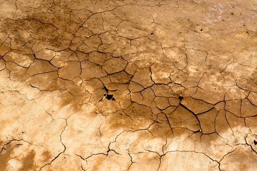 Detail shot of cracked brown and cream mud and clay - Australian Stock Image