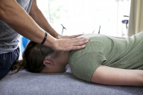 Detail shot of physiotherapist treating a patient's neck - Australian Stock Image
