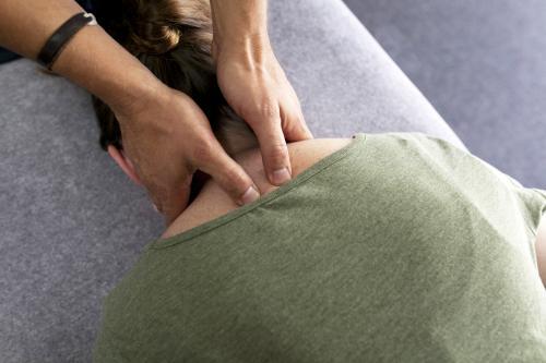 Detail shot of physiotherapist treating a patient's neck - Australian Stock Image
