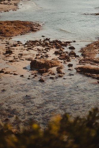 Detail shot of the rocky coast and clear water at Diamond Head Beach, NSW.