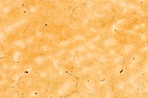 Detail shots of yellow textured and patterned desert claypans with cracks - Australian Stock Image