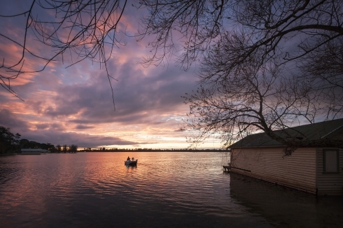 Dinghy on lake at dusk