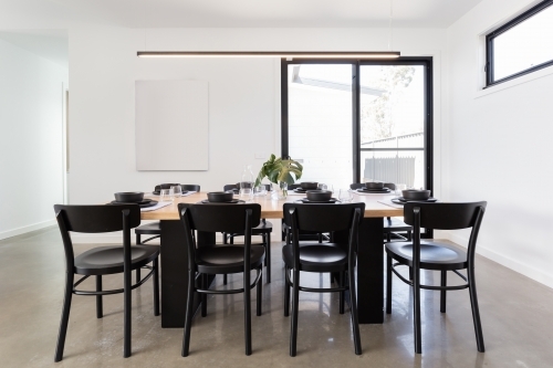 Dining table set for lunch in a contemporary home - Australian Stock Image