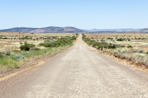dirt road heading towards distant hills - Australian Stock Image