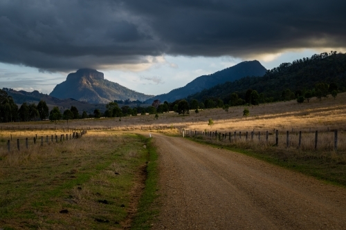 dirt road in front of mountains - Australian Stock Image