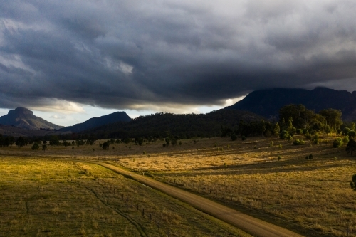 dirt road in front of mountains - Australian Stock Image