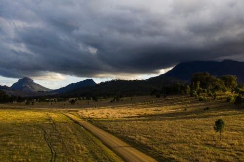 dirt road in front of mountains - Australian Stock Image