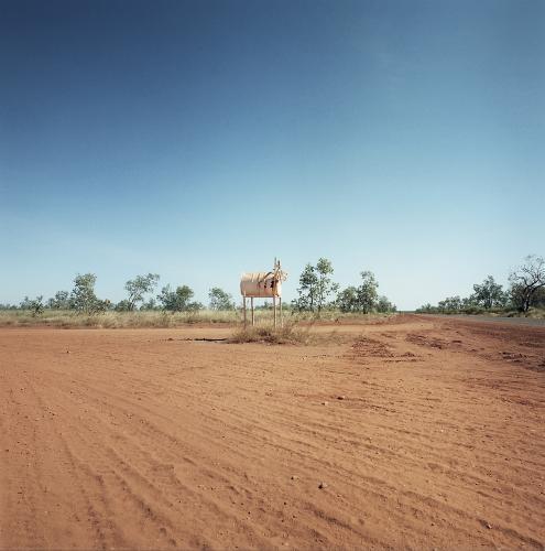 Dirt road in remote town with large metal letterbox - Australian Stock Image