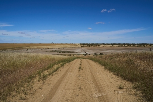 Dirt road leading to dry lake bed